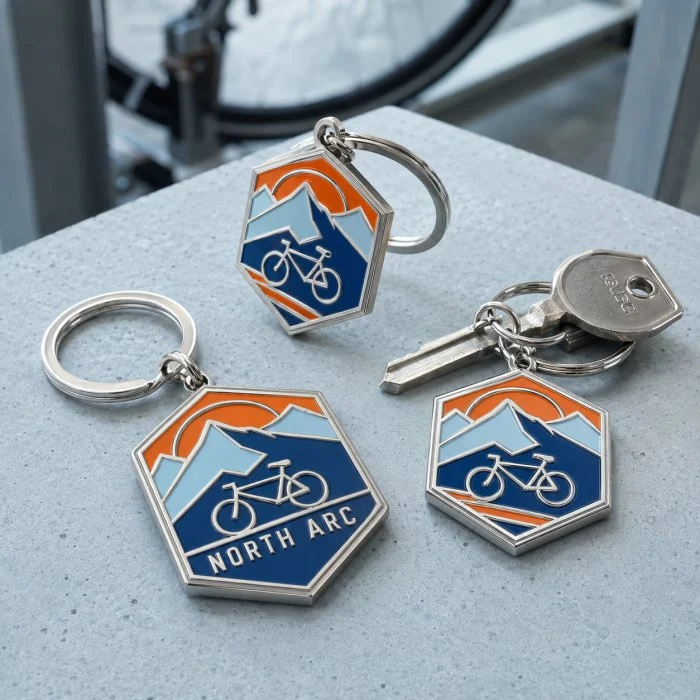 Custom soft enamel cycling keychains with silver metal and blue enamel