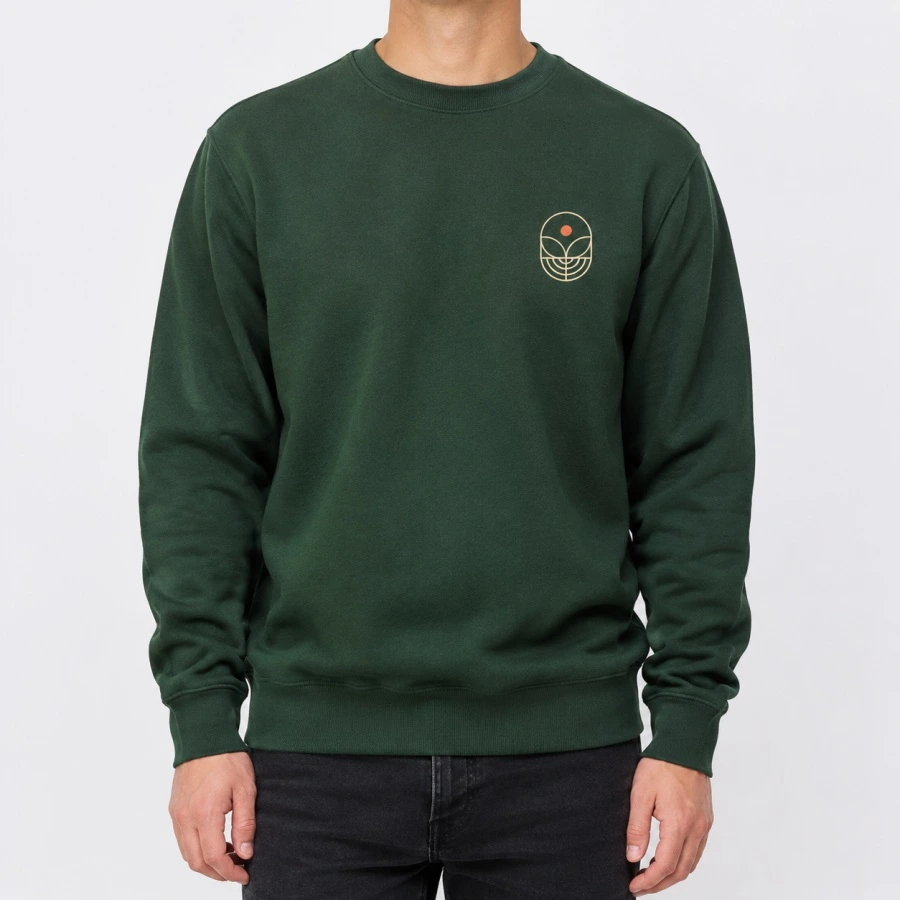 Forest green custom crewneck sweatshirt with a minimalist left-chest print on a light grey background