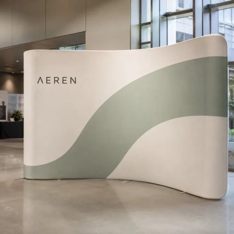 Minimal S-curve tension fabric backdrop at a Vancouver design expo